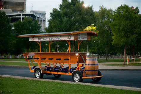 A colorful pedal tavern parked on a street in Nashville, ready for a fun-filled tour through the city's vibrant neighborhoods.