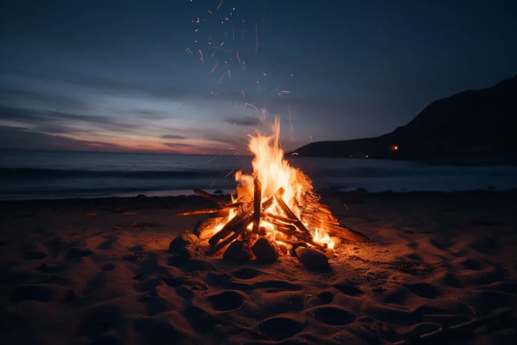 A solitary beach bonfire with flames flickering against the backdrop of crashing waves, creating a tranquil scene of summer relaxation.