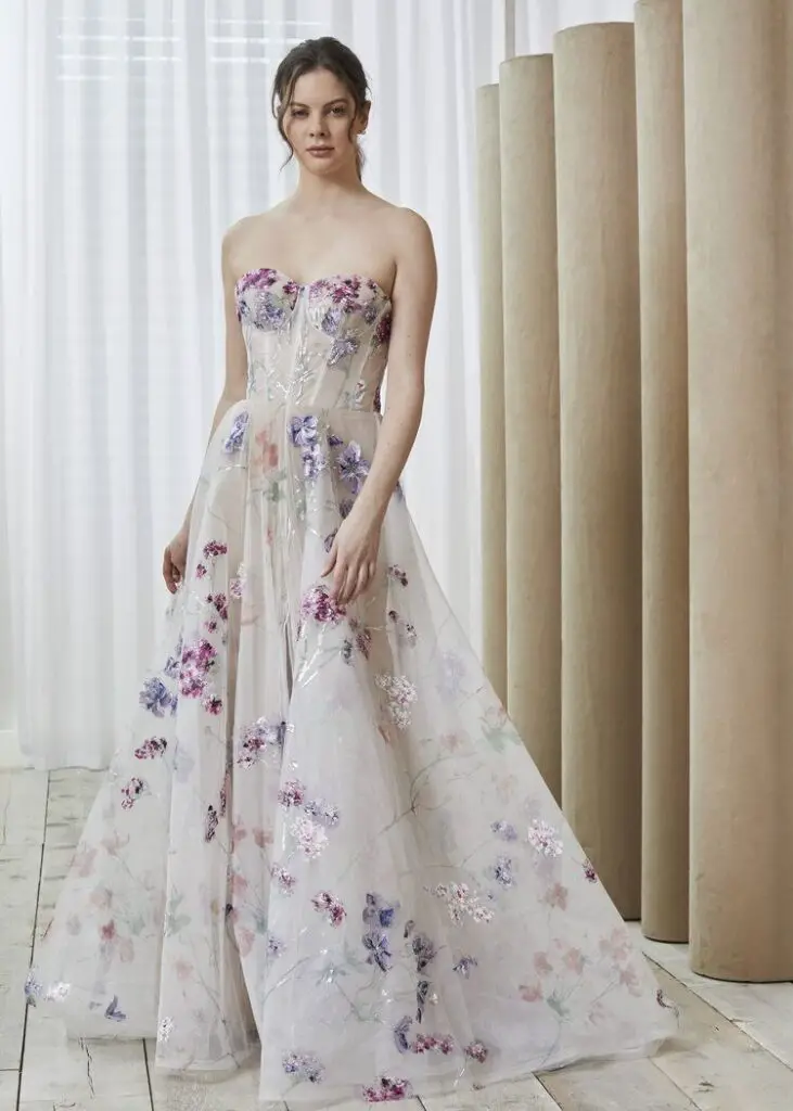 Women wearing elegant floral gown wedding dresses adorned with delicate blooms.